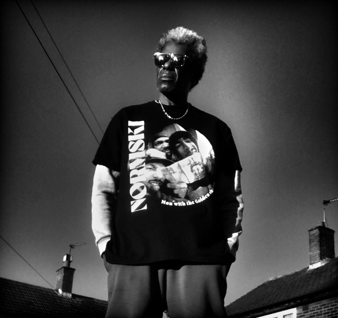 NORMSKI: Man With The Golden Shutter - Official T-Shirt